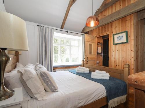 a bedroom with a bed with towels on it at Trewince Manor Cottage in Truro