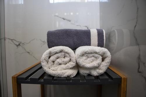 a couple of towels sitting on a rack in a bathroom at Olivemare Holidays in Nea Irakleia