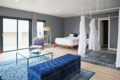 a living room with a bed and a blue couch at Good Hotels Downtown Denver in Denver