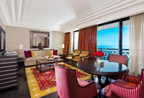 a living room with a couch and a table at The Leela Palace Chennai in Chennai