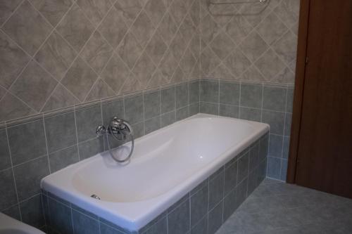 a bath tub with a faucet in a bathroom at Contedoro Living in Ariano Irpino
