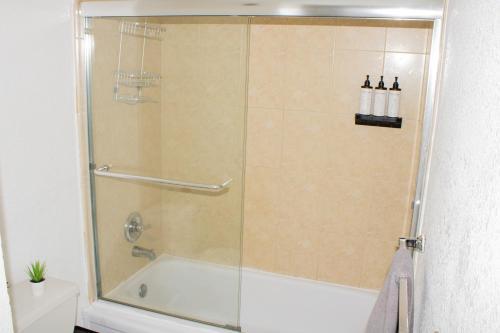 a shower with a glass door in a bathroom at Breathtaking Beach Condo!!! in Hollywood