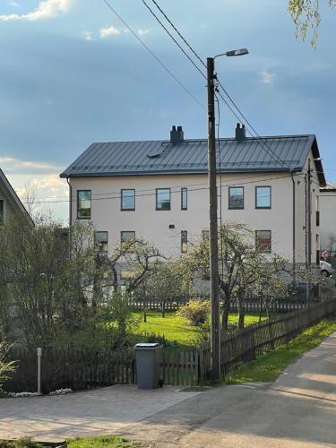 a white house with a fence in front of it at Condo in the heart of Katariina, near Kotka City Center! in Kotka