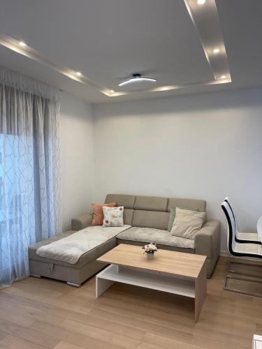 a living room with a couch and a coffee table at Apartment Trebinje Sun in Trebinje