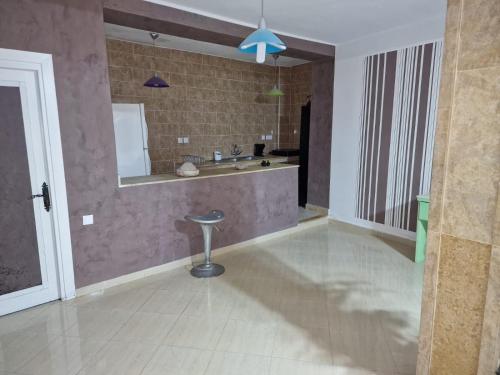 a bathroom with a sink and a mirror and a stool at Azla beach in Azla