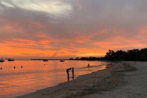 a person standing on the beach at sunset at * * Magnífico * * apto en la playa * *Costazul 405 in Santa Marta