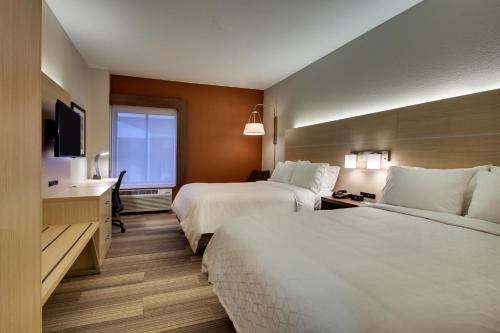 a hotel room with two beds and a television at Holiday Inn Express Hotel & Suites Cedar Rapids I-380 at 33rd Avenue, an IHG Hotel in Cedar Rapids