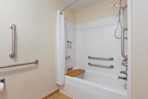 a bathroom with a bath tub and a shower stall at Candlewood Suites Washington North, an IHG Hotel in Washington