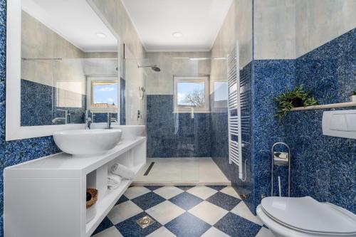 a bathroom with a sink and a toilet at Villa Delmati in Tugare