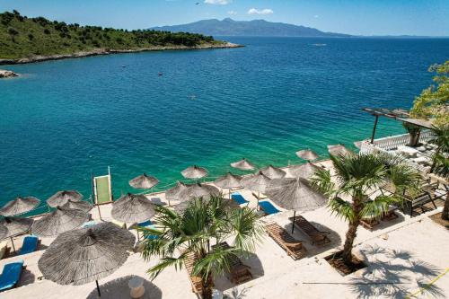 an aerial view of a beach with umbrellas and the ocean at Luxury Villa Alisja Sarande with Private Beach in Sarandë