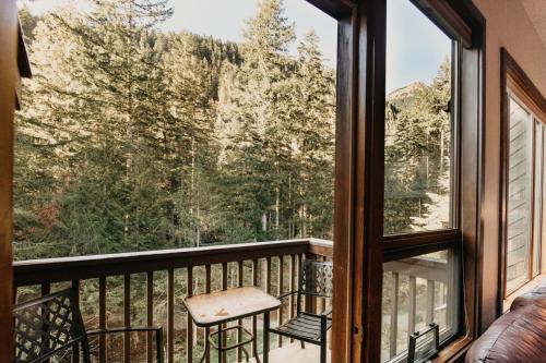 a balcony with a view of the mountains at 55SW - Fireplace - D W - WithD - Sleeps 4 condo in Glacier