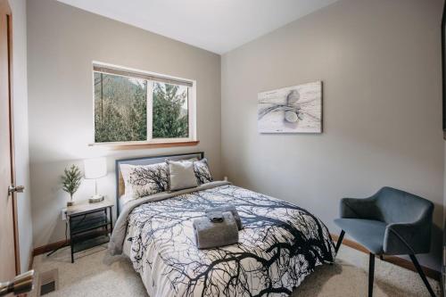 a bedroom with a bed and a chair and a window at 20GS - WiFi - F P - WithD - Sleeps 6 home in Glacier