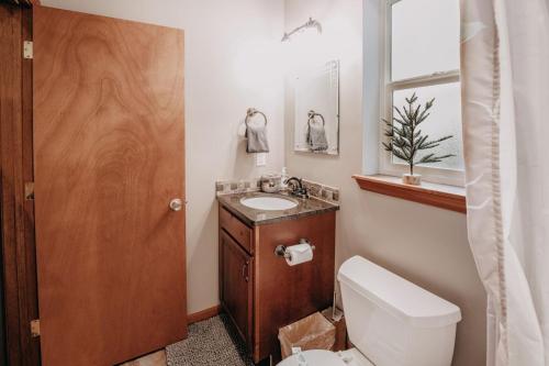 a bathroom with a toilet and a sink at 20GS - WiFi - F P - WithD - Sleeps 6 home in Glacier