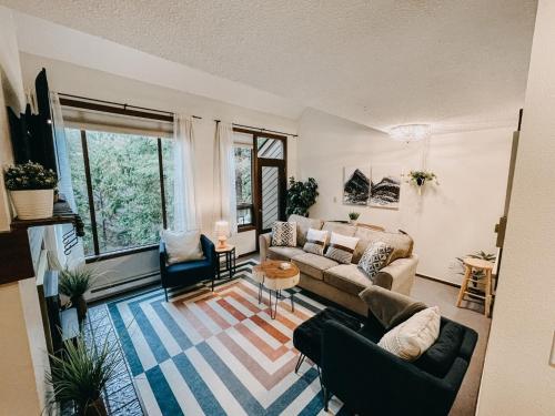 a living room with a couch and two chairs at 73SW - WiFi - F P - WithD - Sleeps 6 home in Glacier