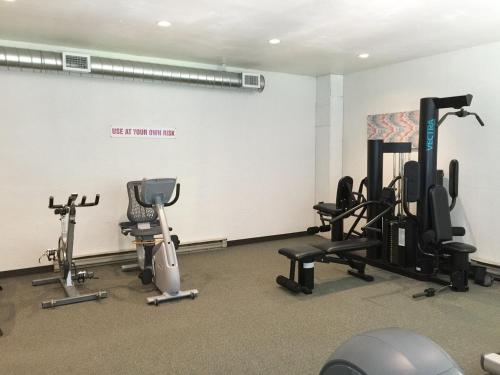 a gym with several exercise equipment in a room at 73SW - WiFi - F P - WithD - Sleeps 6 home in Glacier