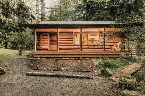 a log cabin in the middle of a forest at 76GS - Genuine Log Cabin - WiFi - Pets Ok - Sleeps 4 home in Glacier