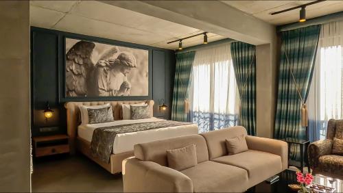 a bedroom with a king sized bed and a couch at Sandora Boutiuqe Hotel in Yalıkavak