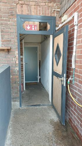 an entrance to a brick building with a door at Snow White in Kürten