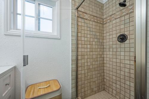a bathroom with a shower with a toilet and a sink at Cozy home away from home in Los Angeles