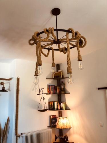 a chandelier hanging from the ceiling in a room at Vlami's House Andros in Apróvaton