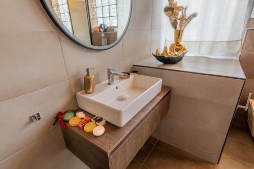 a bathroom with a sink and a mirror at Villa George in Skiathos in Skiathos Town