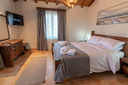 a bedroom with a bed with a teddy bear on a table at Villa George in Skiathos in Skiathos Town