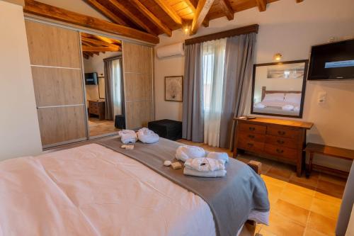a bedroom with a bed with two stuffed animals on it at Villa George in Skiathos in Skiathos Town