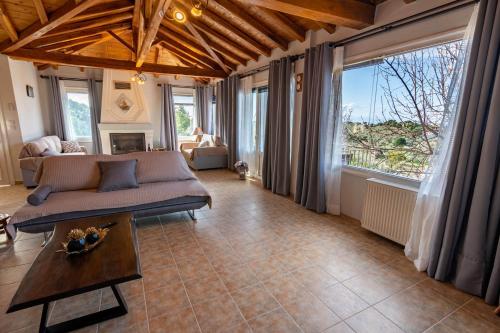 a living room with a couch and a table at Villa George in Skiathos in Skiathos Town