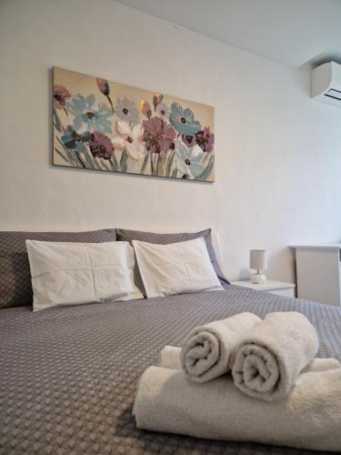 a bedroom with a bed with towels on it at Apartment and Room Marija in Krk