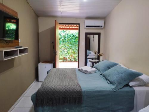 a bedroom with a large bed and a window at Casa da Tetê in Fernando de Noronha