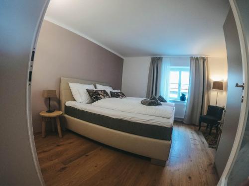 a bedroom with a bed with a large mirror at Apartment an der Rugenstiege in Steiner Altstadt in Krems an der Donau