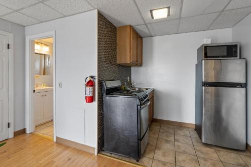 a kitchen with a stove and a refrigerator at Mt Royal Motel in Old Orchard Beach