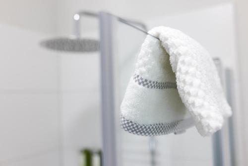 a towel hanging on a rack in front of a mirror at Struck Landhotel & SPA in Attendorn