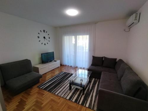 a living room with a couch and a coffee table at Apartman MiS Trebinje in Trebinje