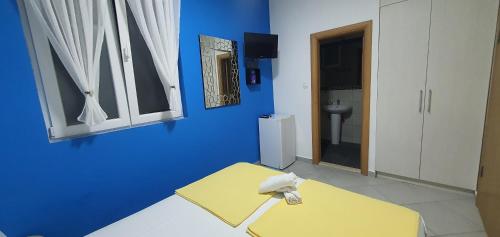 a blue room with a sink and a toilet at Villa D&B Budva in Budva