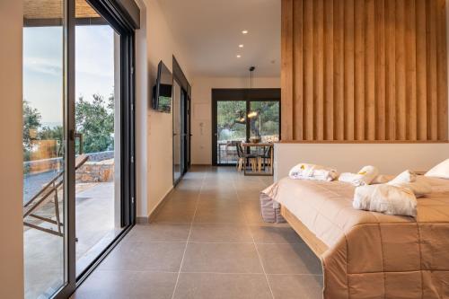 a bedroom with a bed and a balcony at Casatino Villas in Kalianeika