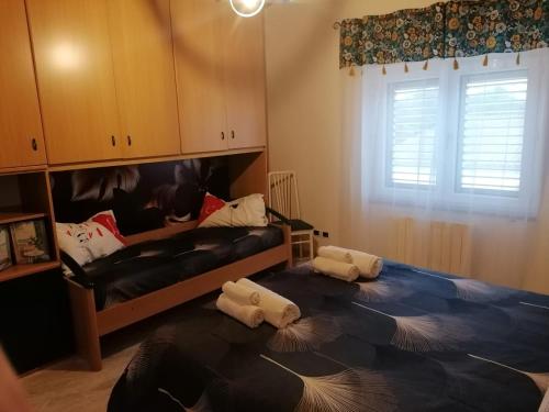 a bedroom with a bed with two pillows on the floor at La casa degli ulivi in Turri