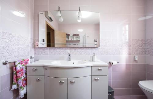 a bathroom with a sink and a mirror at Apartment Anchor in Šibenik