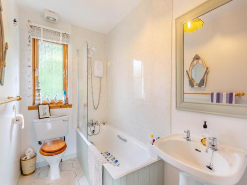 a bathroom with a sink and a toilet and a tub at Riverfoot in Glenelg