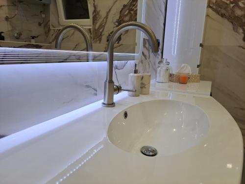 a bathroom sink with a white counter top with a sink at Apartment Monaco in Rijeka