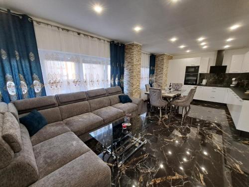 a living room with a couch and a dining room at Apartment Monaco in Rijeka