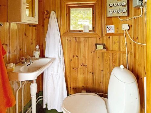 a bathroom with a toilet and a sink at Holiday home LIDKÖPING IX in Tallbacken