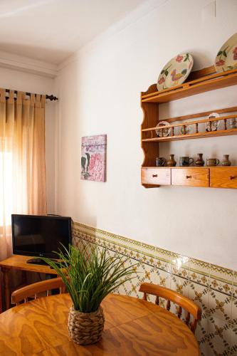 a dining room with a table with a plant on it at Casa Maria in Albufeira