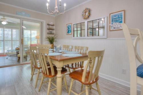 a dining room with a table and chairs at Hidden Treasure in Oak Island