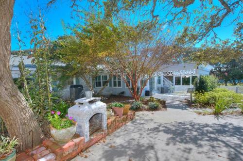 a house with a fireplace in a yard at Hidden Treasure in Oak Island