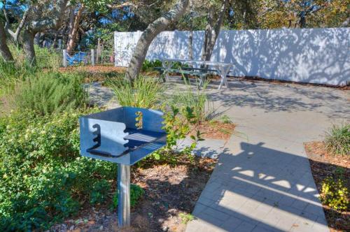 a blue mailbox in a park with a bench at Hidden Treasure in Oak Island