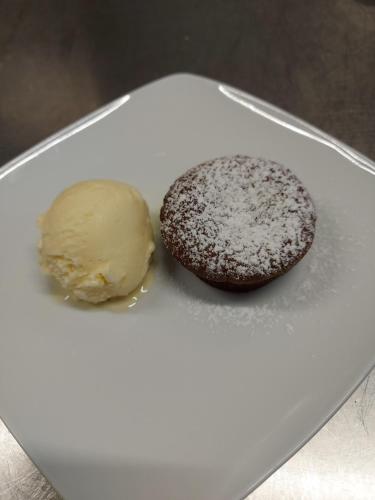 a chocolate cookie and ice cream on a white plate at Moon Garden in Mongardino