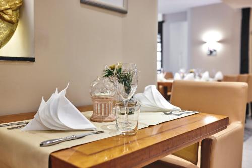 a table with a white napkin and glasses on it at Struck Landhotel & SPA in Attendorn
