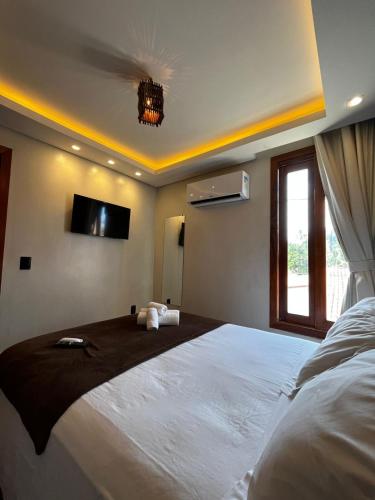 Ένα ή περισσότερα κρεβάτια σε δωμάτιο στο Milos Hotel Icaraizinho