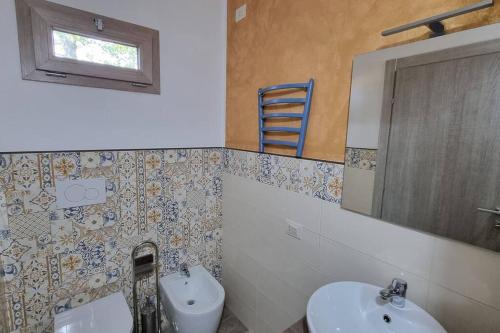 bagno con lavandino, servizi igienici e specchio di appartamento Margherita a Crespina